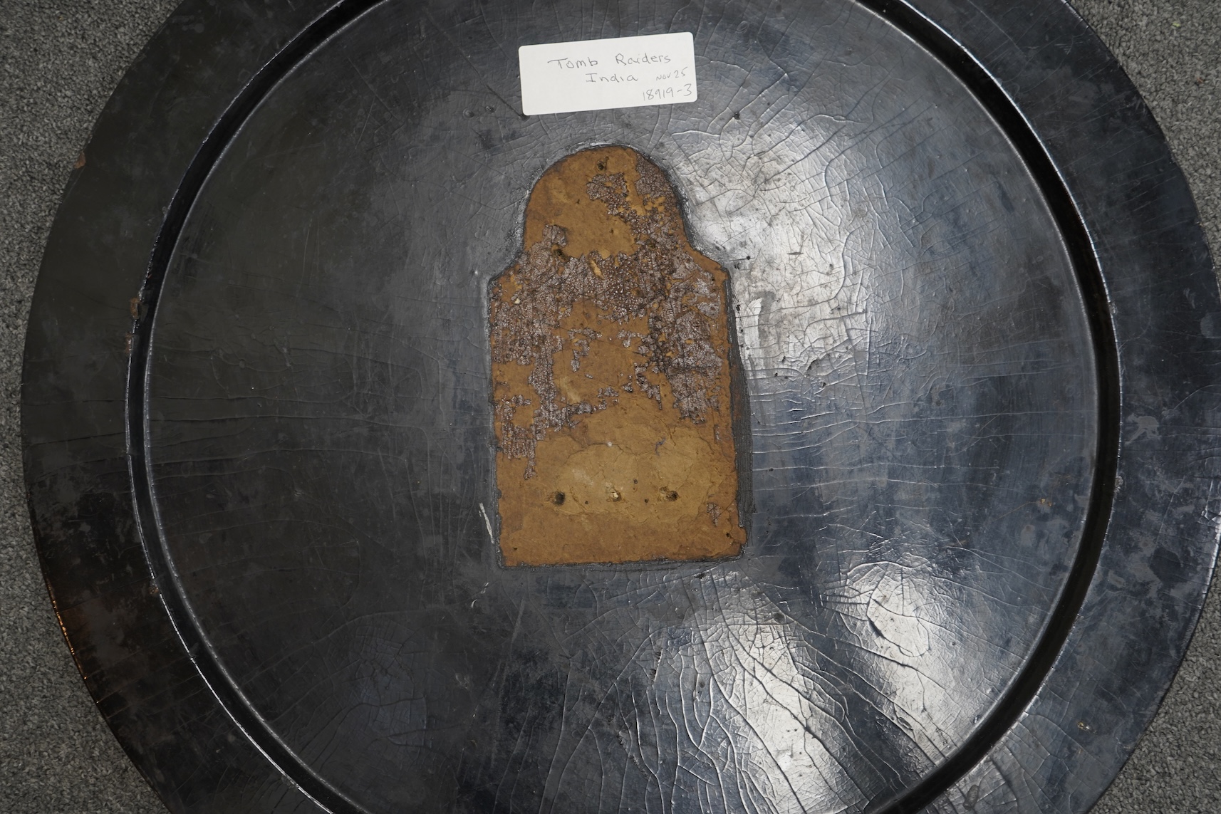 A Victorian japanned table top, depicting Indian grave robbers
